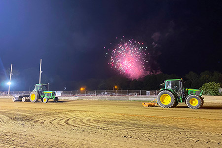 A tractor pull at night.